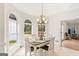 Bright dining room with chandelier, a farmhouse style table, and arched windows at 2615 Hampton Locust Grove Rd, Locust Grove, GA 30248