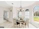 Sunlit dining area features a wood table, four white chairs, and arched windows at 2615 Hampton Locust Grove Rd, Locust Grove, GA 30248
