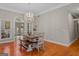 Bright dining room featuring elegant chandelier, natural lighting, and wood floors at 2615 Hampton Locust Grove Rd, Locust Grove, GA 30248