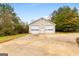 Detached two-car garage with a concrete driveway and green foliage at 2615 Hampton Locust Grove Rd, Locust Grove, GA 30248