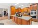 Spacious kitchen with a large island, wood cabinets, and stainless steel appliances at 2615 Hampton Locust Grove Rd, Locust Grove, GA 30248
