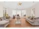 Large living room featuring wood floors, neutral decor, and ample seating at 2615 Hampton Locust Grove Rd, Locust Grove, GA 30248