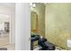 Unique powder room featuring gold framed mirror, dark walls, and a pedestal sink at 2615 Hampton Locust Grove Rd, Locust Grove, GA 30248