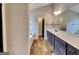 Bright bathroom with wood-look floors, double vanity, and separate tub at 483 Castle Top Ln, Lawrenceville, GA 30045