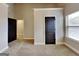 Bedroom featuring neutral carpeting, gray walls, a black door, and window at 483 Castle Top Ln, Lawrenceville, GA 30045