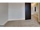 Bedroom featuring neutral carpeting, gray walls, and black door at 483 Castle Top Ln, Lawrenceville, GA 30045