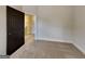Bedroom featuring neutral carpeting, gray walls, and black door at 483 Castle Top Ln, Lawrenceville, GA 30045