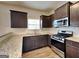 Well-equipped kitchen with granite countertops, stainless steel appliances, and ample storage at 483 Castle Top Ln, Lawrenceville, GA 30045