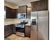 Kitchen featuring stainless steel appliances, granite countertops, and dark brown cabinets at 483 Castle Top Ln, Lawrenceville, GA 30045