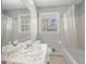 Bathroom featuring a marble countertop, white fixtures, and bright natural light from two windows at 5217 Hollyhock Rd, Douglasville, GA 30135