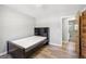 Bedroom with a bed against the wall with hardwood floors and light colored walls at 5217 Hollyhock Rd, Douglasville, GA 30135