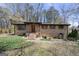 Charming brick home featuring shuttered windows, a covered front porch, and a neatly landscaped front yard at 5217 Hollyhock Rd, Douglasville, GA 30135