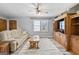 Inviting living room with a plush sofa, soft rug, and a charming ceiling fan for a cozy atmosphere at 5217 Hollyhock Rd, Douglasville, GA 30135