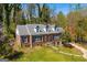 Charming brick home featuring a classic design, well-maintained lawn, mature trees, and inviting curb appeal at 2255 Beecher Sw Rd, Atlanta, GA 30311