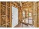 Framed interior view with exposed studs, a white door, and natural light streaming through the windows at 2255 Beecher Sw Rd, Atlanta, GA 30311