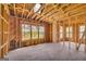 Open living space with exposed wood framing, multiple windows, and hardwood flooring, offering plenty of natural light at 2255 Beecher Sw Rd, Atlanta, GA 30311