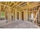 Open living space featuring exposed wood framing, hardwood floors, and large windows, presenting an opportunity for renovation at 2255 Beecher Sw Rd, Atlanta, GA 30311