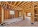 Spacious living area featuring exposed framing, hardwood floors, and natural light streaming through windows, perfect for renovation at 2255 Beecher Sw Rd, Atlanta, GA 30311