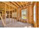 Exposed framing creates distinct living spaces with lots of natural light from windows, providing an open canvas for renovation at 2255 Beecher Sw Rd, Atlanta, GA 30311