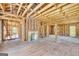 Open-concept living room with exposed brick chimney, wood flooring, and ample natural light at 2255 Beecher Sw Rd, Atlanta, GA 30311