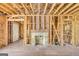 Exposed brick fireplace, wood framing, and unfinished hardwood floors in a living room undergoing renovation at 2255 Beecher Sw Rd, Atlanta, GA 30311