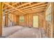 Framed living room with brick chimney, hardwood floors, and a bright yellow door, waiting for renovation at 2255 Beecher Sw Rd, Atlanta, GA 30311