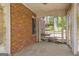 Enclosed porch with brick wall, vintage flooring, and an open view to the backyard, perfect for relaxation at 2255 Beecher Sw Rd, Atlanta, GA 30311