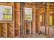 Exposed framing highlighting window placements, wood paneling, and brick accents throughout the unfinished room at 2255 Beecher Sw Rd, Atlanta, GA 30311
