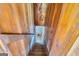 Wooden stairway descends to a stone-walled basement, creating a rustic, inviting transition to the lower level at 2255 Beecher Sw Rd, Atlanta, GA 30311