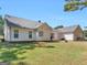 Well-maintained backyard featuring a spacious lawn and a freshly painted white home exterior at 1293 Coan Dr, Locust Grove, GA 30248