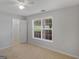 Cozy bedroom with plush carpet, a bright window, and a spacious closet at 1293 Coan Dr, Locust Grove, GA 30248