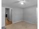 Neutral bedroom with light carpet, ceiling fan, and freshly painted gray walls at 1293 Coan Dr, Locust Grove, GA 30248