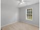 Neutral bedroom with light carpet, ceiling fan, window with blinds, and freshly painted gray walls at 1293 Coan Dr, Locust Grove, GA 30248