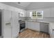 Bright kitchen with white cabinets, stainless appliances, and eat-in area at 1293 Coan Dr, Locust Grove, GA 30248