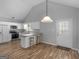 Bright kitchen features white cabinets, stainless appliances, breakfast bar, and door to the dining area at 1293 Coan Dr, Locust Grove, GA 30248