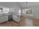 Kitchenette features white cabinetry and ample natural light from a large window and glass door at 1293 Coan Dr, Locust Grove, GA 30248