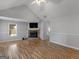 Inviting living room with vaulted ceilings, a brick fireplace, and attractive wood flooring at 1293 Coan Dr, Locust Grove, GA 30248