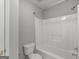 Bathroom features shower with white tub, toilet, neutral walls, and shower head at 1293 Coan Dr, Locust Grove, GA 30248