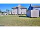 A spacious backyard with a shed, patio seating, and mature trees offers outdoor living and entertainment at 1058 Hartwell Rd, Locust Grove, GA 30248