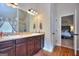 Spacious bathroom featuring a double vanity and tiled floors with views to main bedroom at 1058 Hartwell Rd, Locust Grove, GA 30248