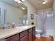 Bathroom with vanity, mirror, and shower/tub combination offers a clean and functional design at 1058 Hartwell Rd, Locust Grove, GA 30248