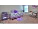 Bedroom showcases a daybed with purple accents, sewing machine, and ample storage providing a versatile room at 1058 Hartwell Rd, Locust Grove, GA 30248