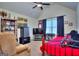 Bedroom featuring a twin bed, dark curtains, TV, and artwork create a cozy personal space at 1058 Hartwell Rd, Locust Grove, GA 30248