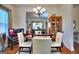 Bright dining area with modern chandelier and glass table, seamlessly connected at 1058 Hartwell Rd, Locust Grove, GA 30248