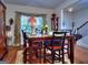 Formal dining room with wood floors and high top table perfect for entertaining at 1058 Hartwell Rd, Locust Grove, GA 30248