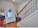 Entryway features hardwood floors, staircase with decorative metal railing, and natural light at 1058 Hartwell Rd, Locust Grove, GA 30248