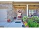 Inviting covered front porch with decorative wreath and potted plants provides a warm welcome at 1058 Hartwell Rd, Locust Grove, GA 30248