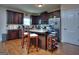Stylish kitchen boasts dark cabinetry, a granite countertop island with seating, and stainless steel appliances at 1058 Hartwell Rd, Locust Grove, GA 30248