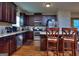 Modern kitchen with granite counters, stainless appliances, dark cabinets, and hardwood floors at 1058 Hartwell Rd, Locust Grove, GA 30248