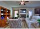 Cozy living room features a brick fireplace, ceiling fan, and comfortable seating at 1058 Hartwell Rd, Locust Grove, GA 30248